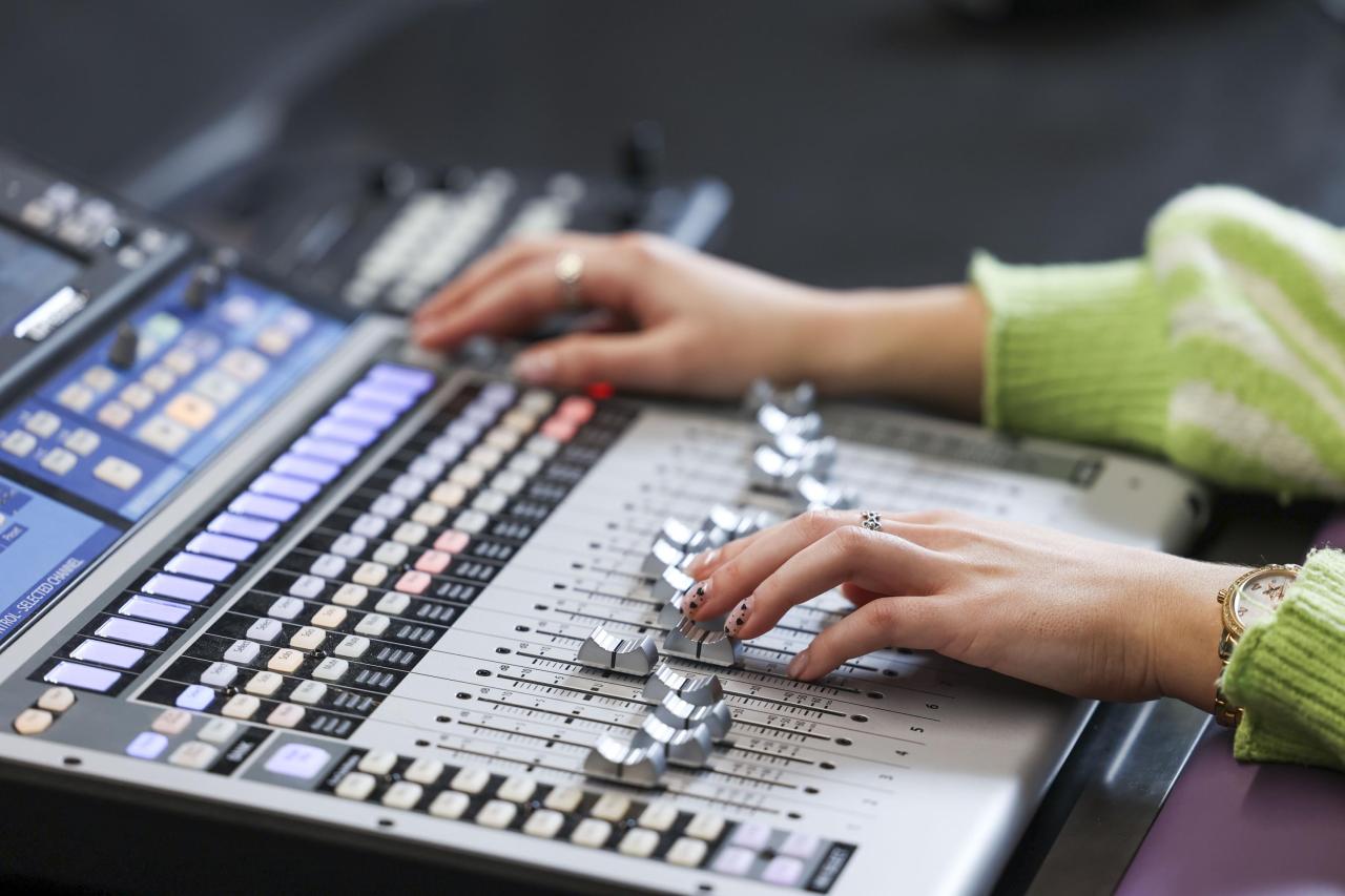 Hands on a mixing desk