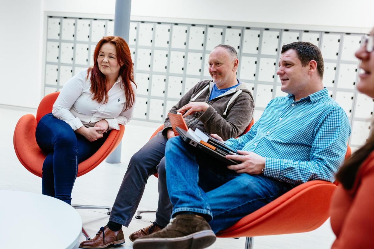 This image shows students sitting and chatting in a group setting