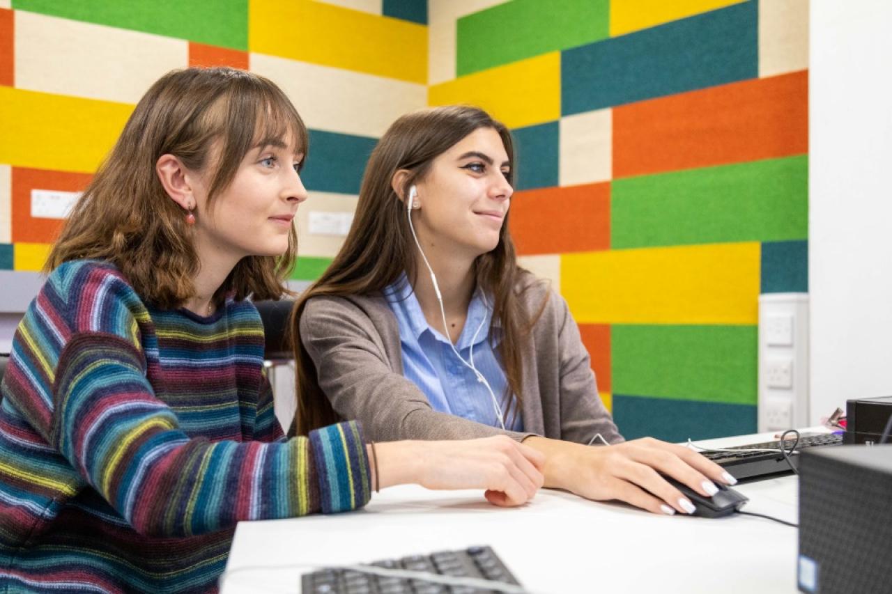 This image shows two female students working on a computer