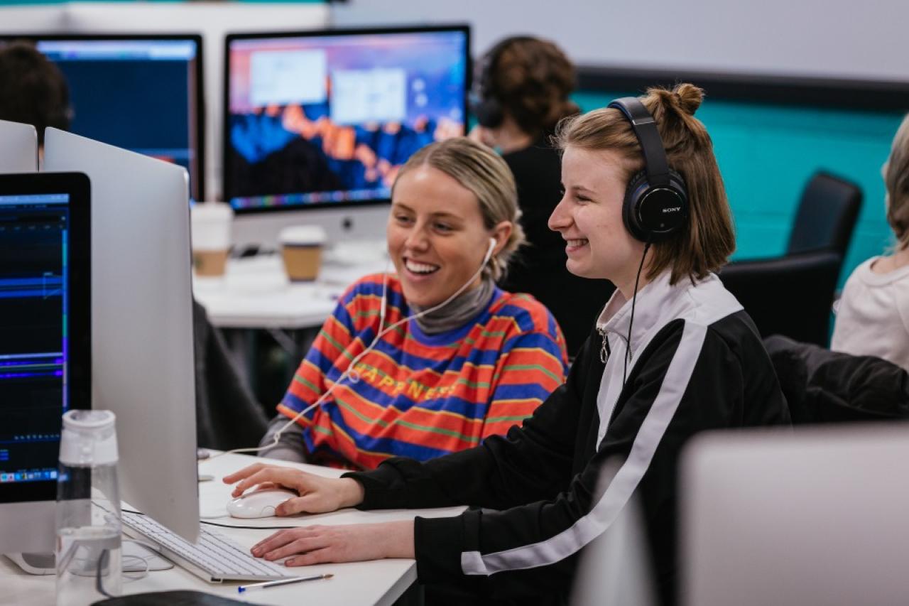 This photo shows to female students working on computer together