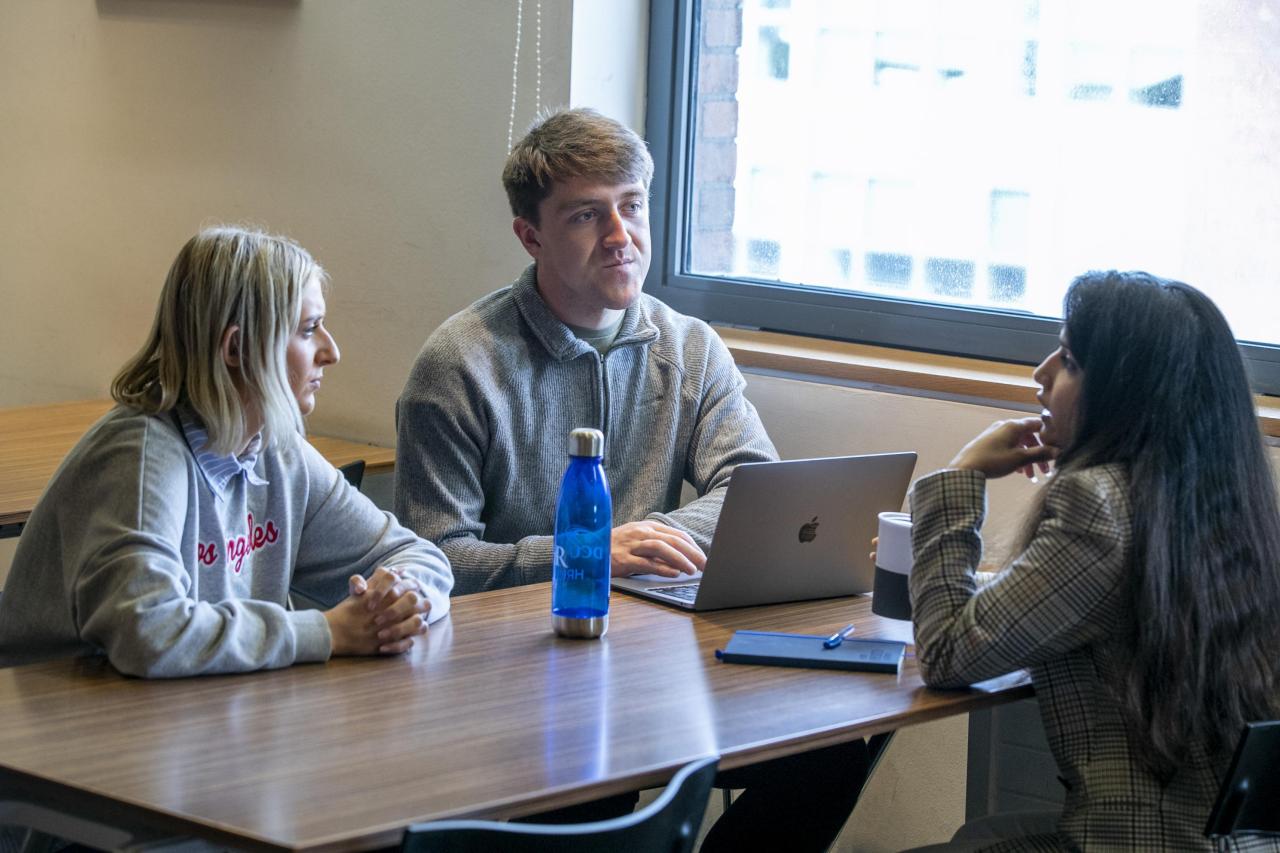 Shows three students chatting on DCU campus 