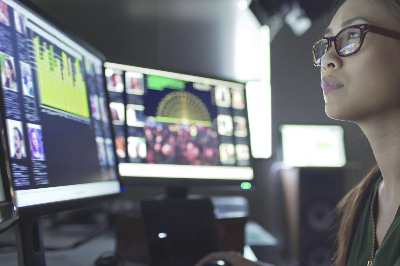 Woman looking at monitors