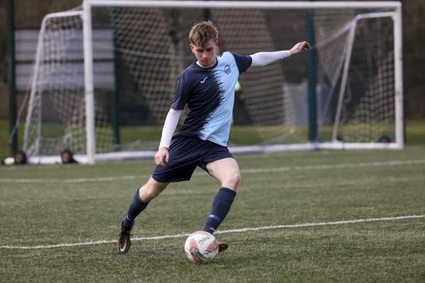 DCU Sport soccer player kicking the ball