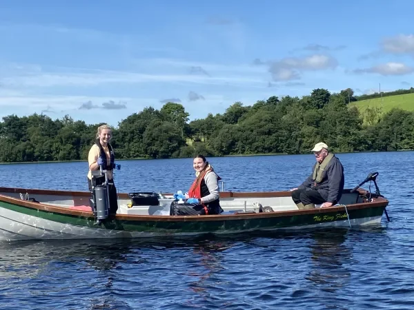 Three researchers on a boat
