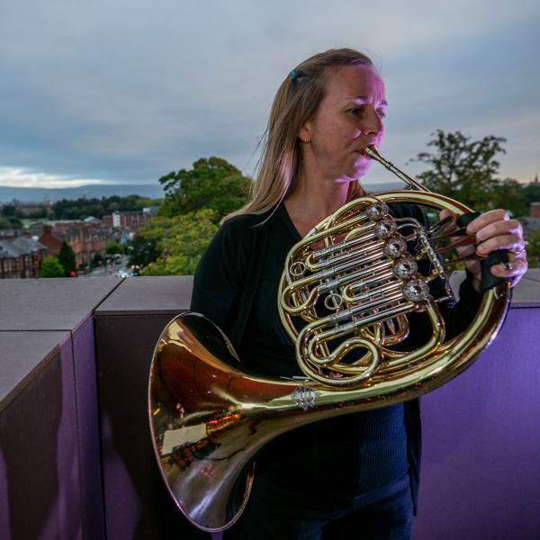 An image of a woman playing a brass instrument during Culture Night