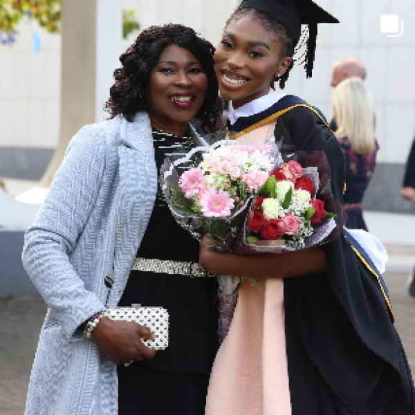 Shows a DCU graduate after ceremony