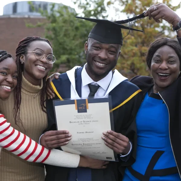 DCU Graduations - family celebrating student graduating