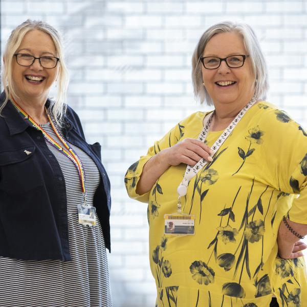 Shows two members of female staff at a staff event in DCU 