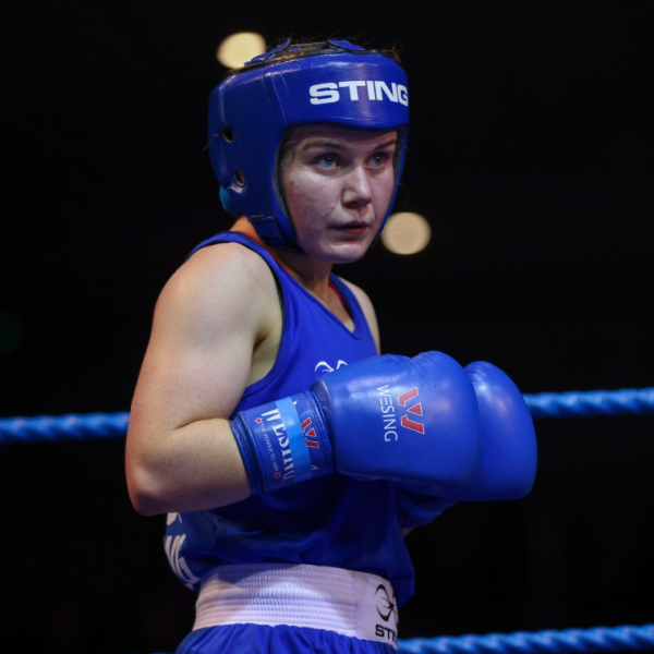 Shows female student in boxing match