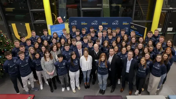 The sport scholars standing in a large group.
