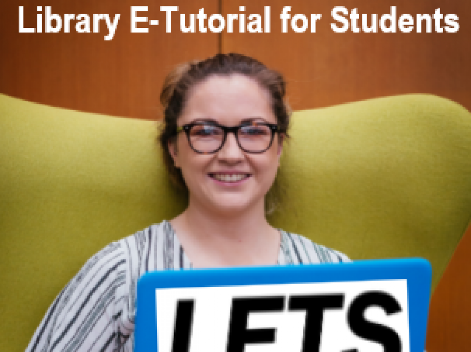 Student holding LETS logo.