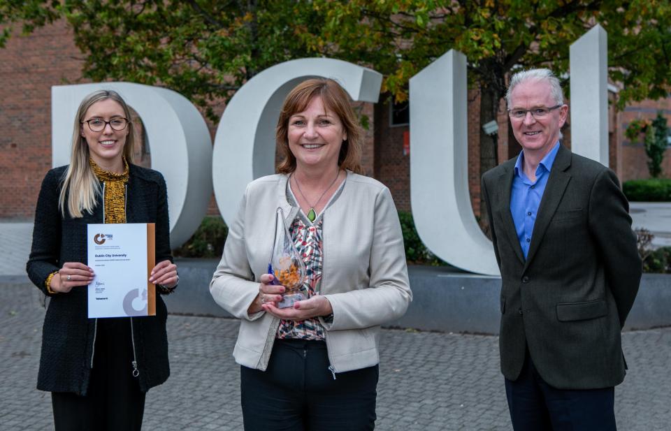 Three colleagues accepting the Athena SWAN bronze award