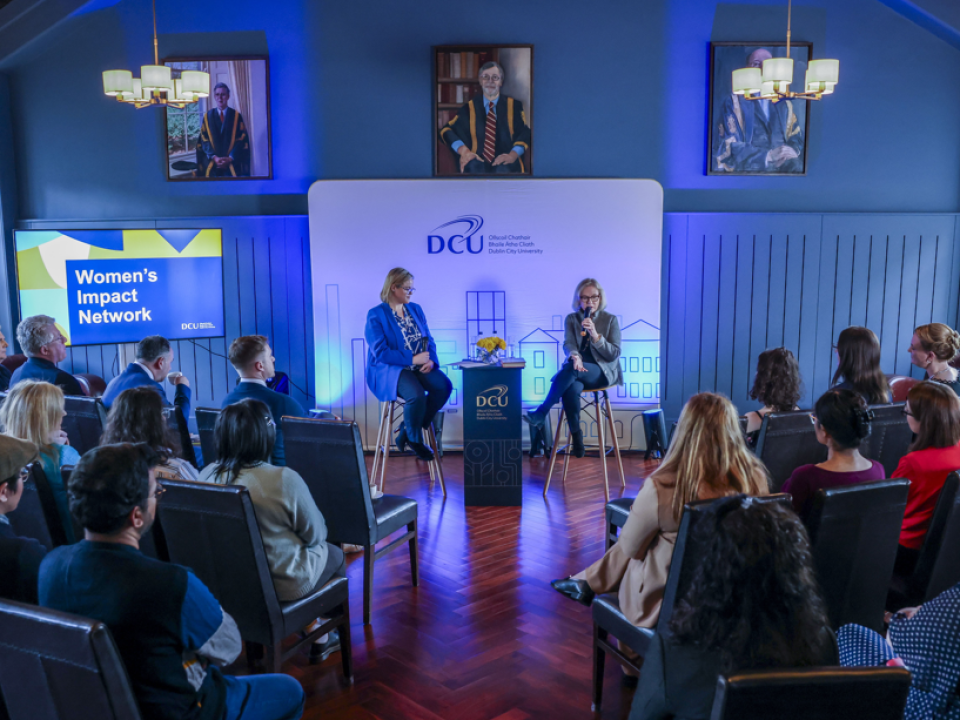 Audience listening to fireside chat between Celine Crawford and Kathy Taylor