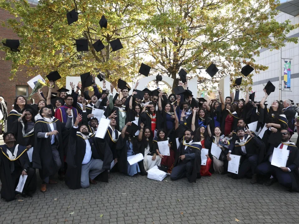 Group of graduates throwing their caps