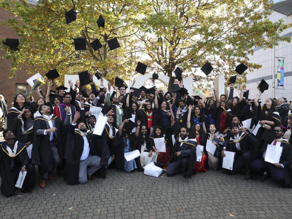 Group of graduates throwing their caps