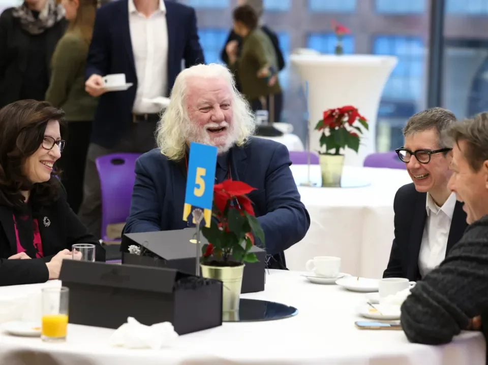 Retiree group sitting around a table laughing and talking