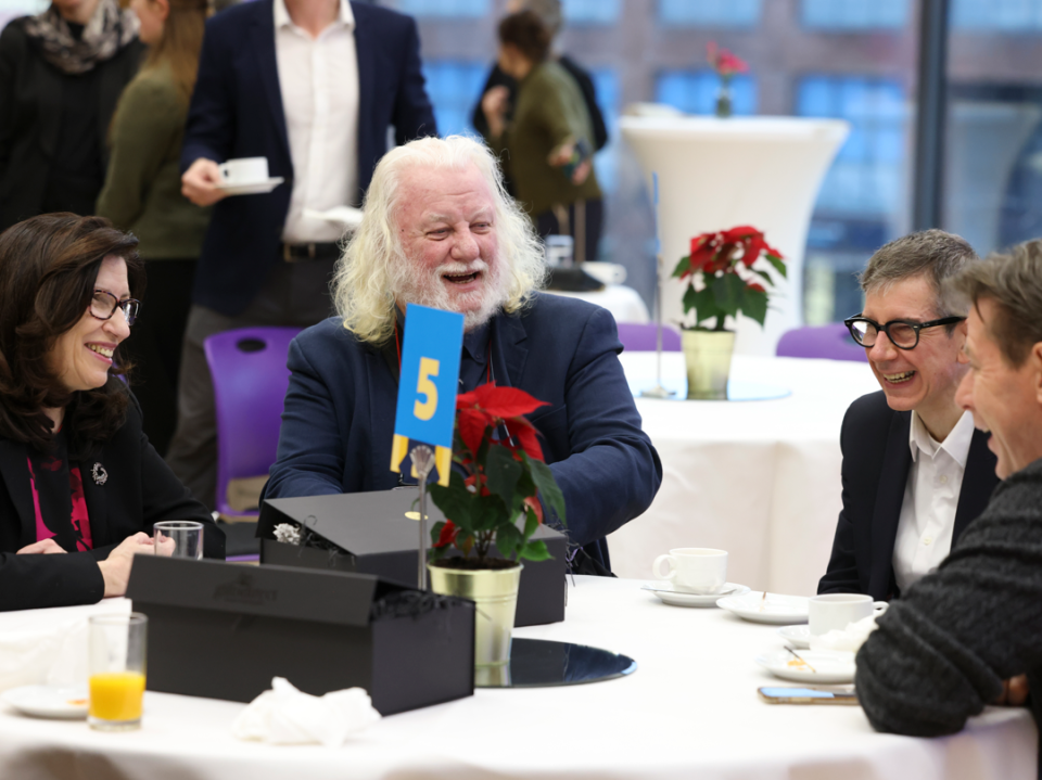 Retiree group sitting around a table laughing and talking