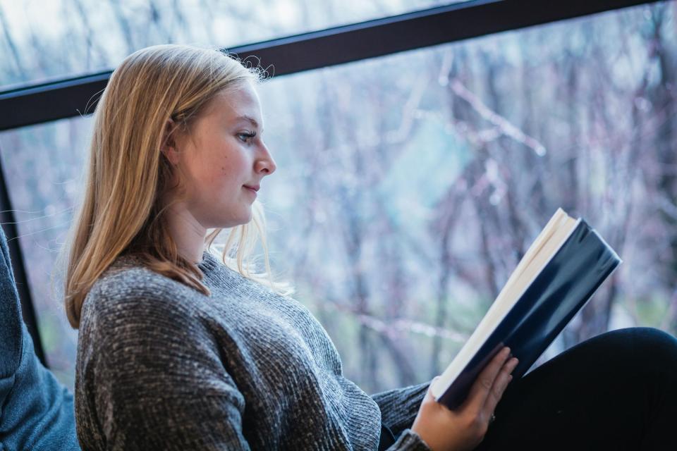 A young student reading a book.