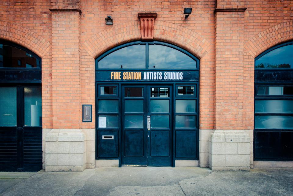 Red brick building and black door of Fire Station Artists' Studios
