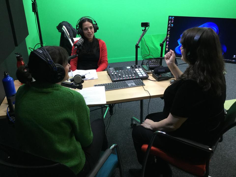 Podcast recording with 3 colleagues chatting with headphones on