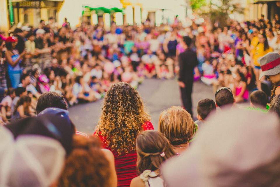 crowd watching a performer in a streetscape