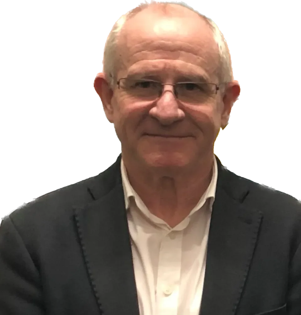 Caucasian male with grey hair wearing white shirt and dark coloured jacket, smiling face on to camera