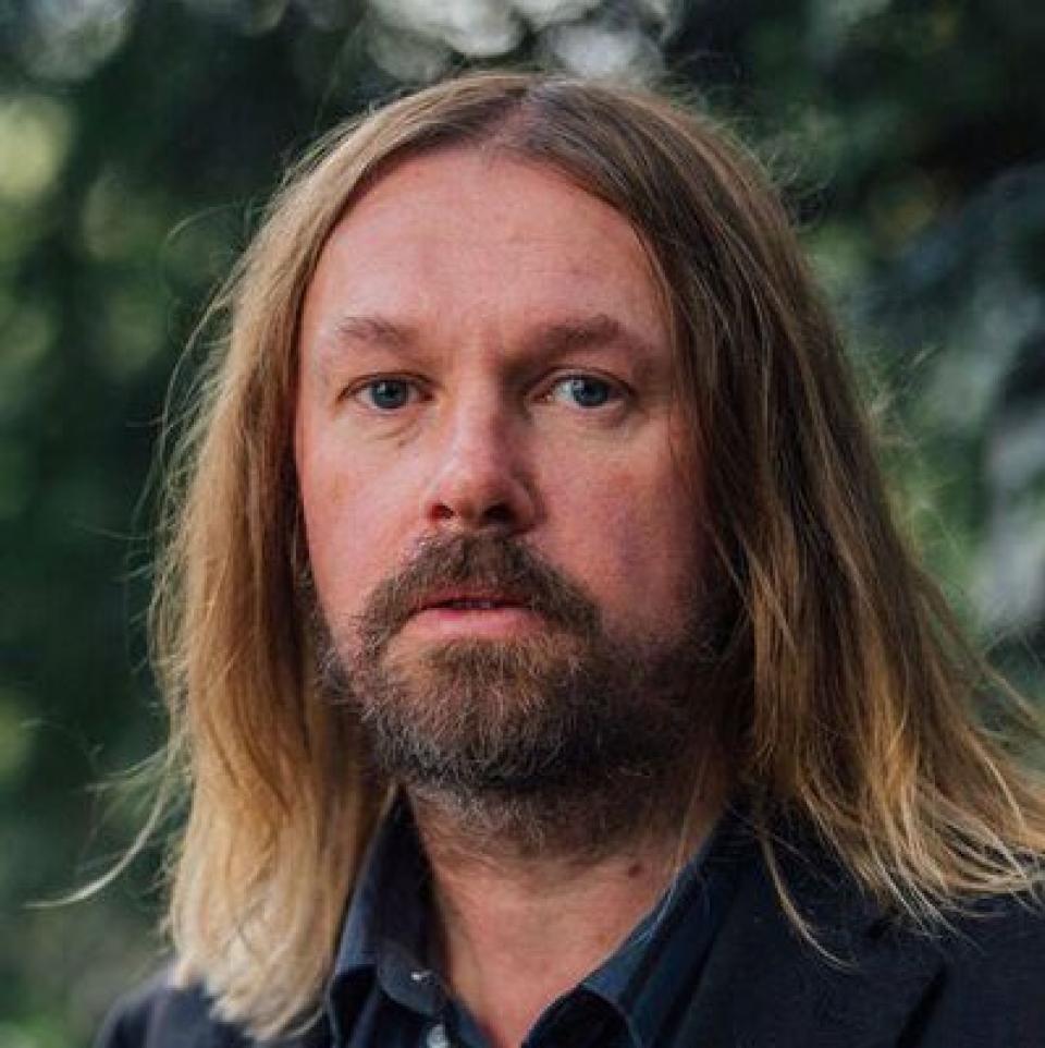 Caucausian male with long brown hair