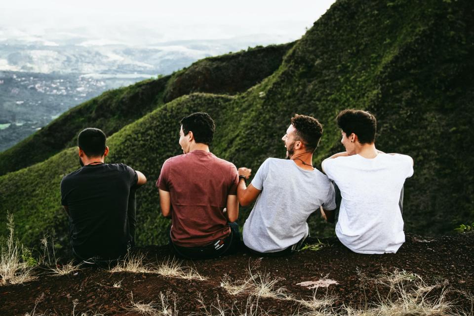 Four men sitting on a mountain