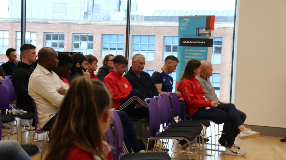 A group of parents sitting and attending an event