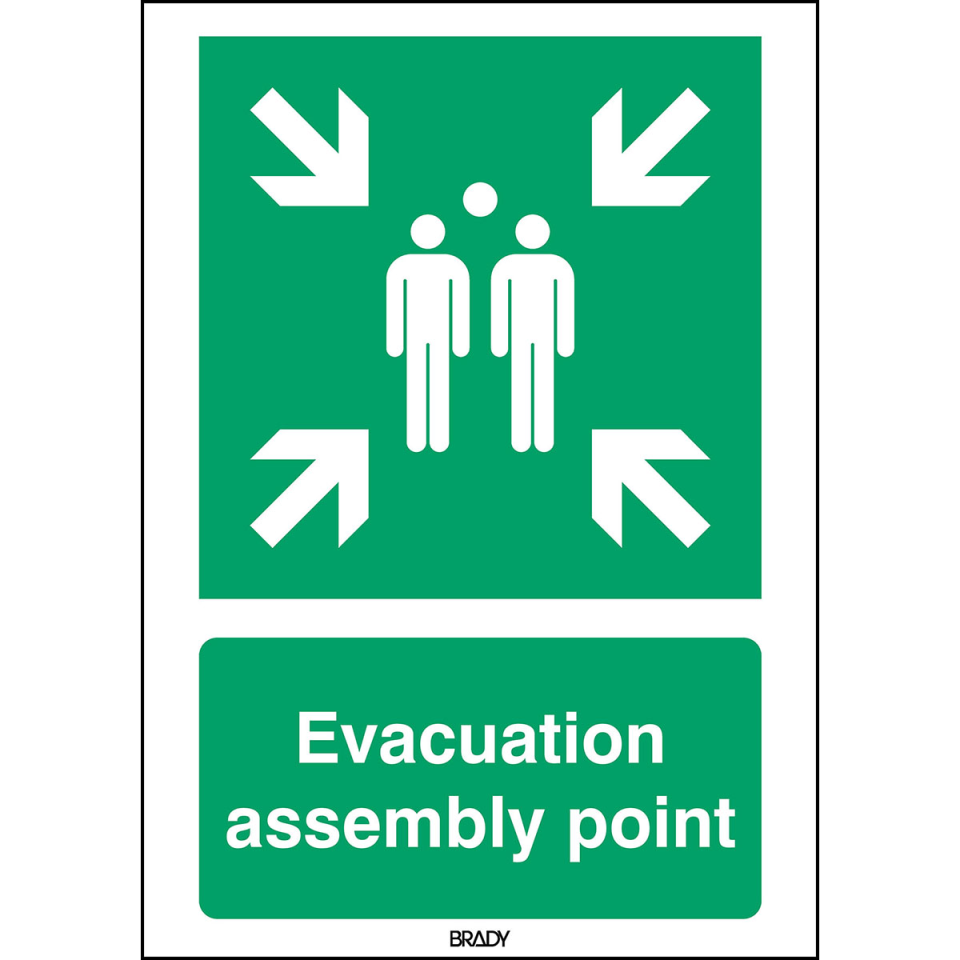 Green and white sign with evacuation assembly point written on it. Four white arrows point inwards towards a graphic of three people in the centre.