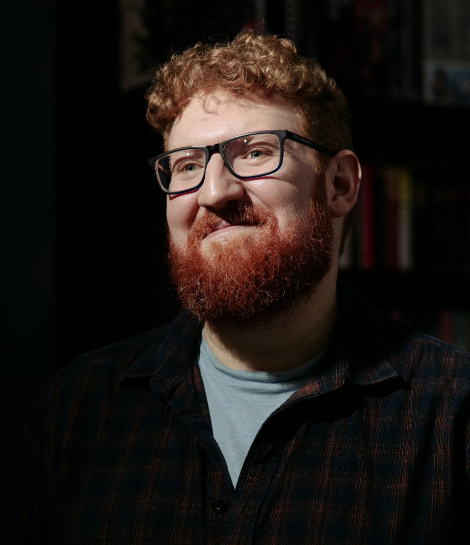 A man with a beard smiling