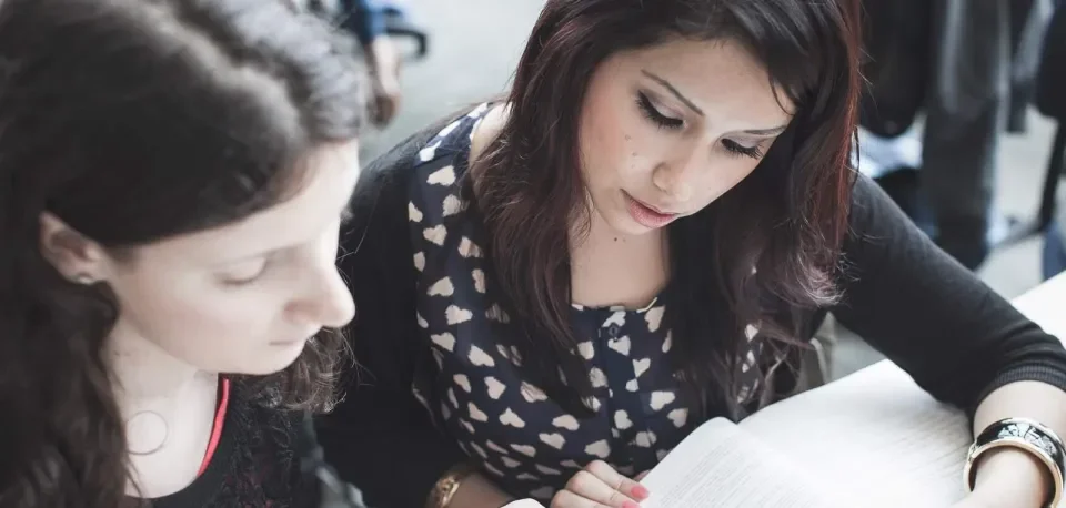 2 students reading at a desk