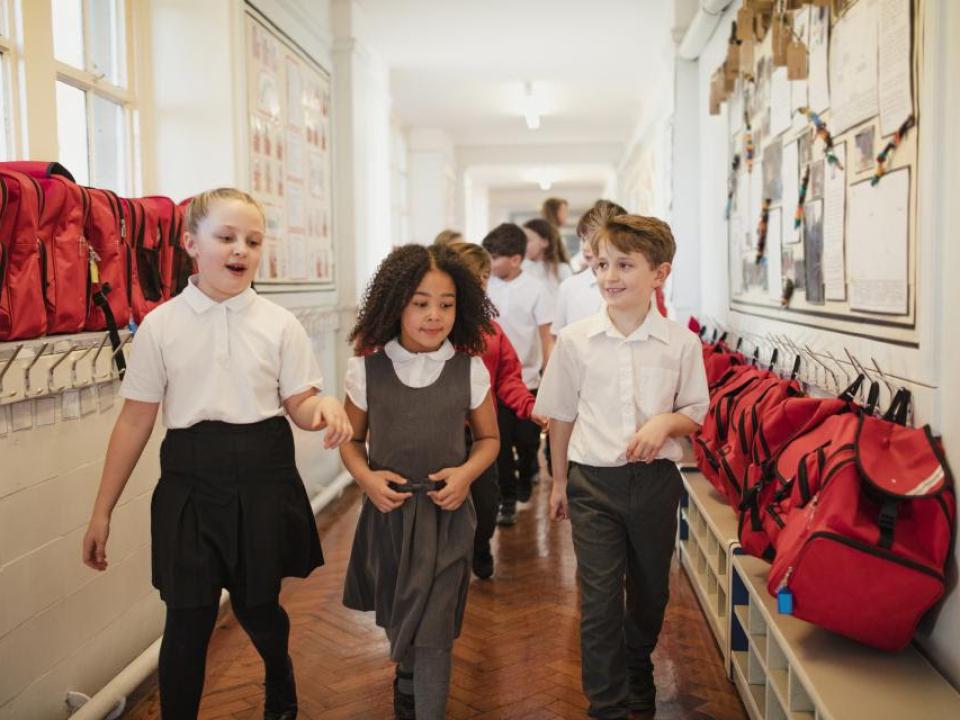School children walking down corridor