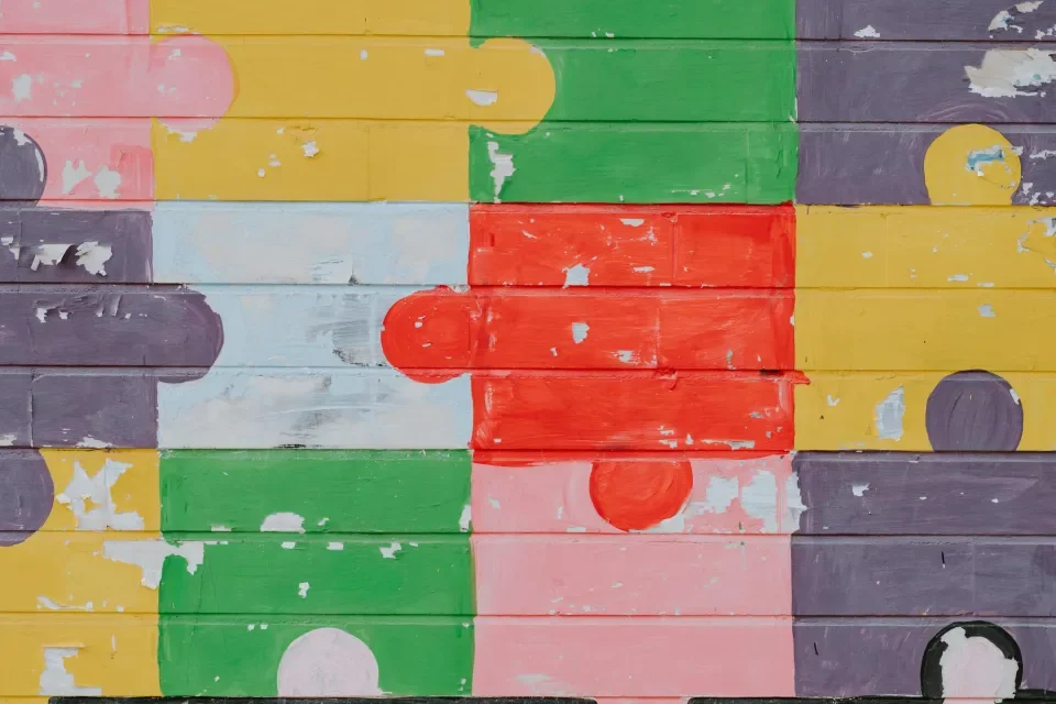 Colourful jigsaw pieces attached together.