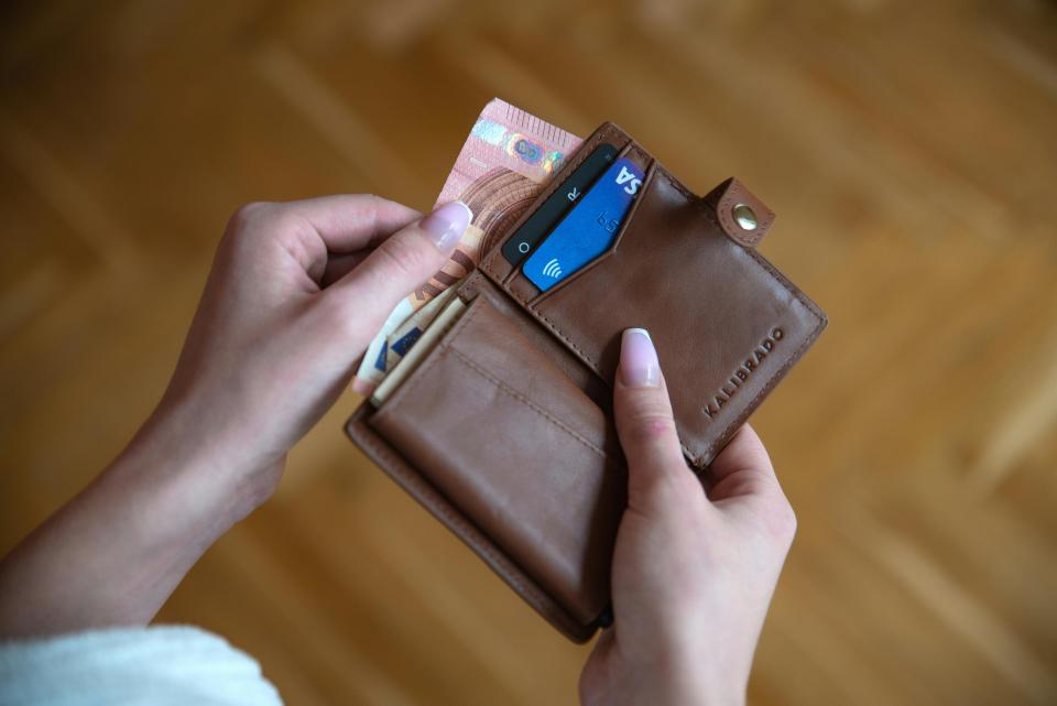 Wallet with cash and cards in it.