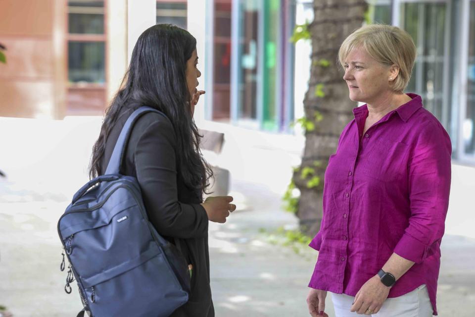 Two colleagues chatting outside