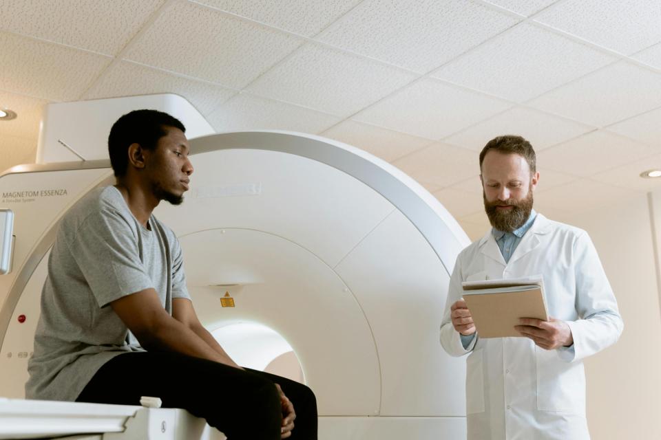 Medical professional and patient at MRI machine