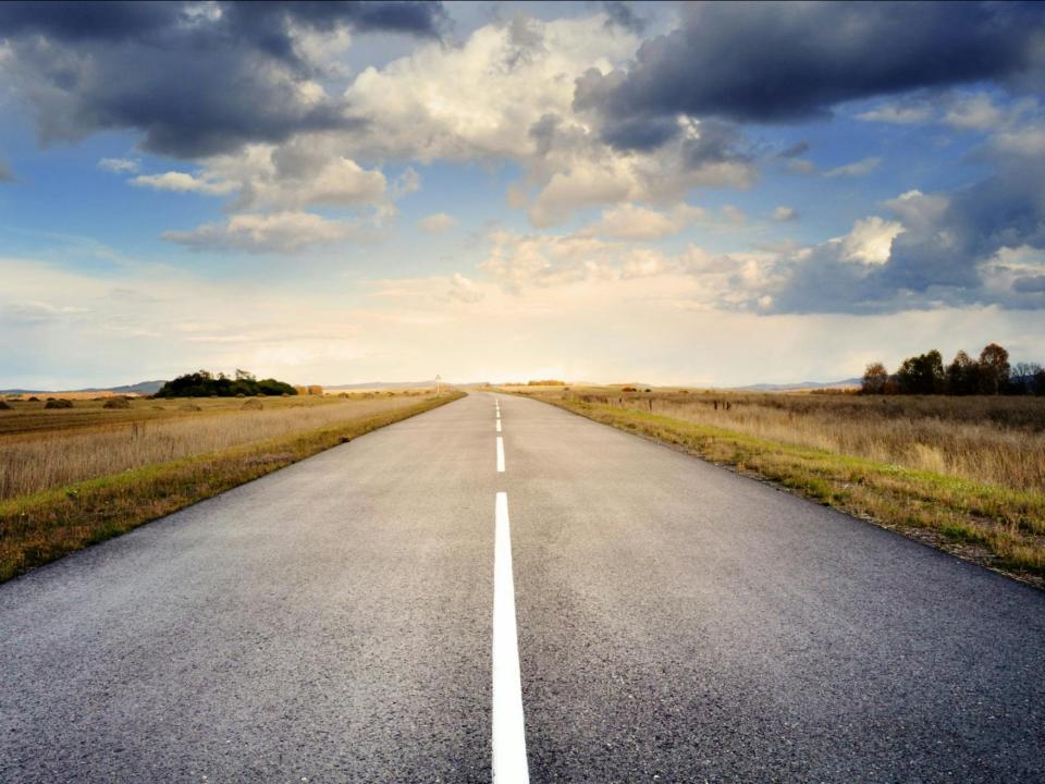 Open road with cloudy sky