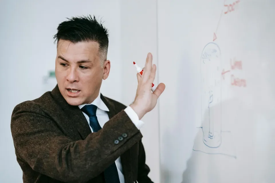 Lecturer writing on white board