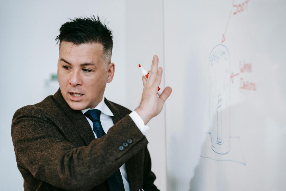 Lecturer writing on white board