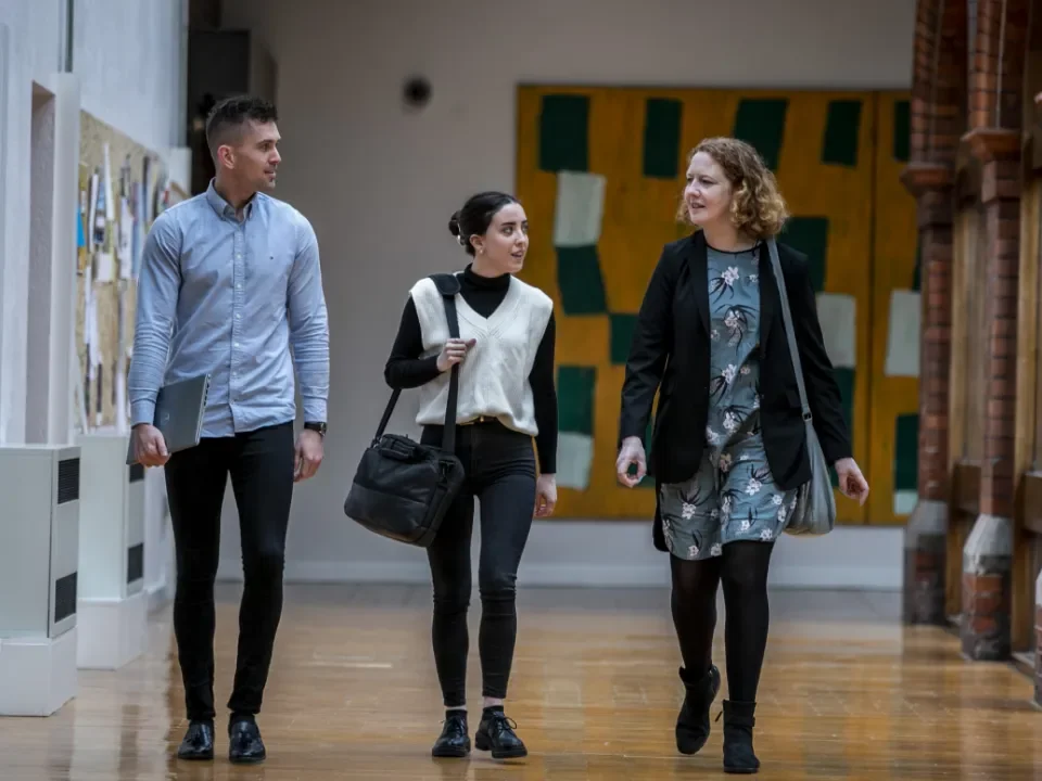 3 colleagues walking down hallway