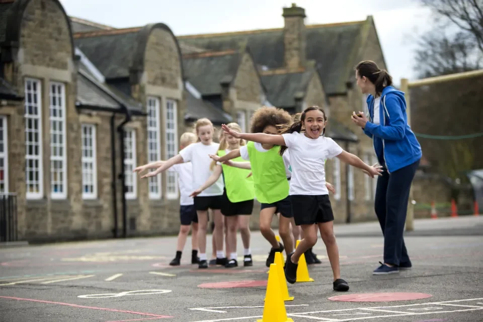 Shows children in schoolyard