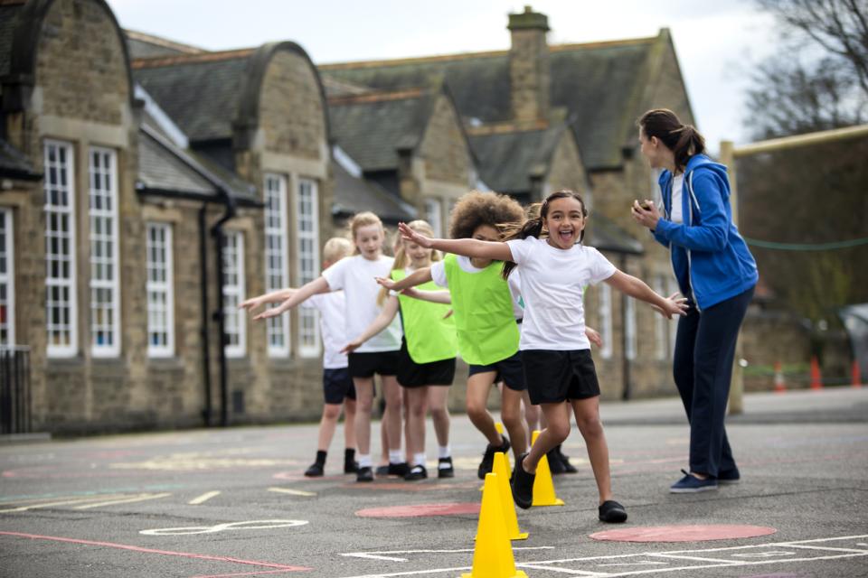 Shows children in schoolyard