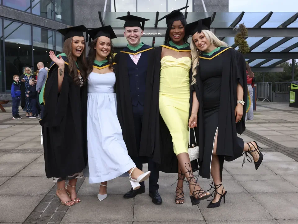 Shows group of DCU graduates outisde The Helix during the Spring Graduation in 2024