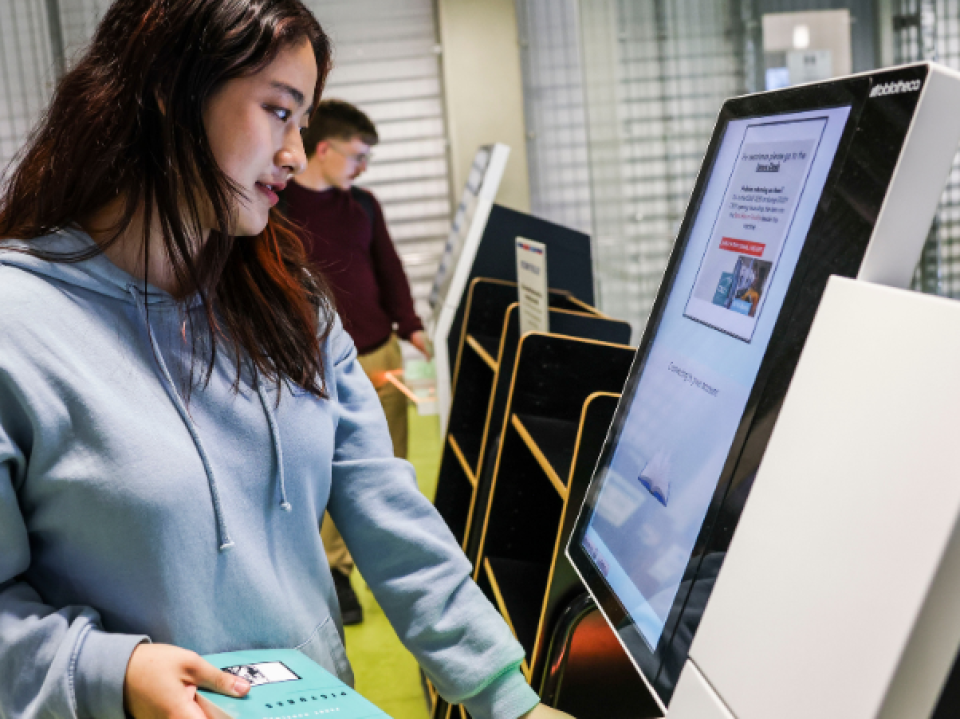 Student using the self service machine in Cregan library