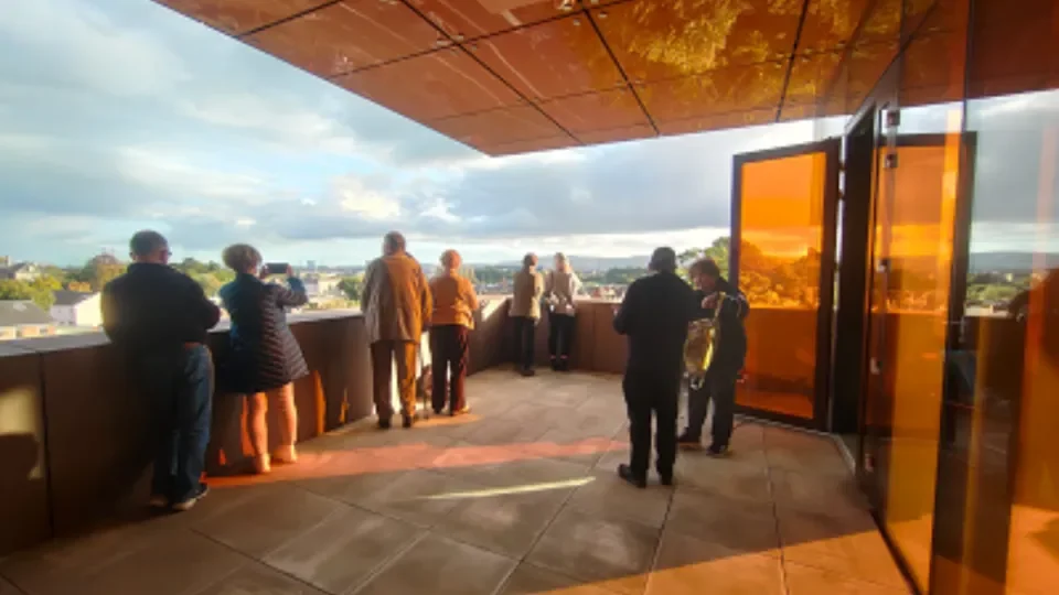 People standing on a balcony looking out