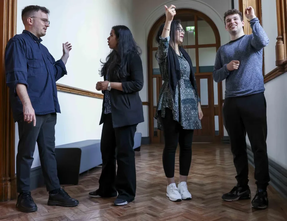 Four colleagues in All Hallows corridor