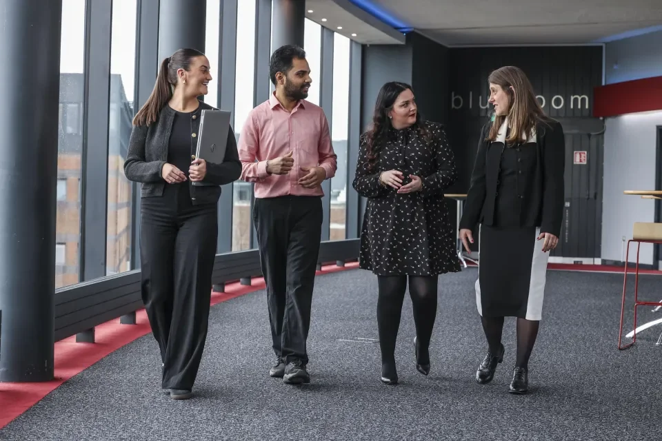 4 staff members walking