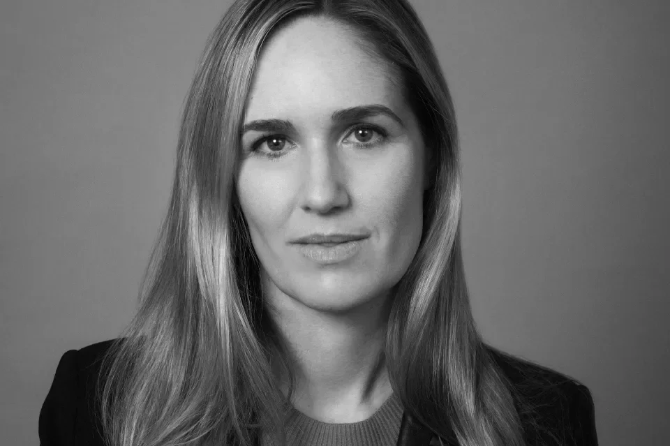 Black and white photo of woman with light hair to her shoulder