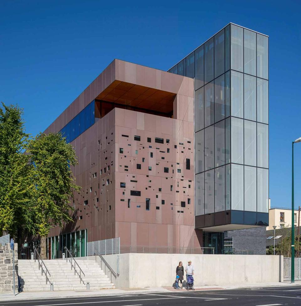 Brown block building with glass extension